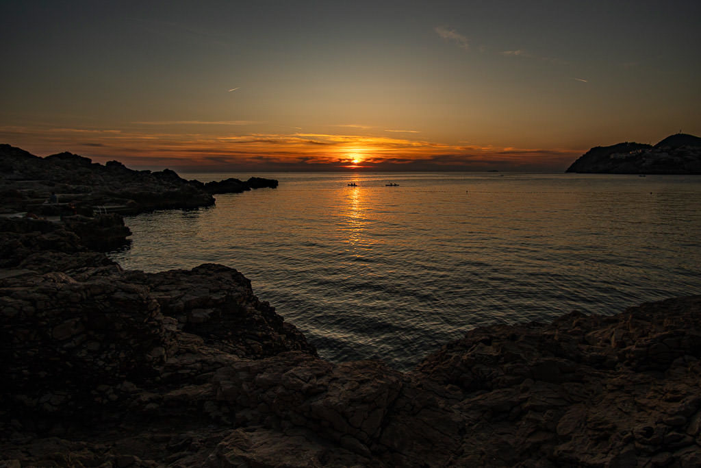 Sunset over Danče Beach with some kayakers enjoying the view