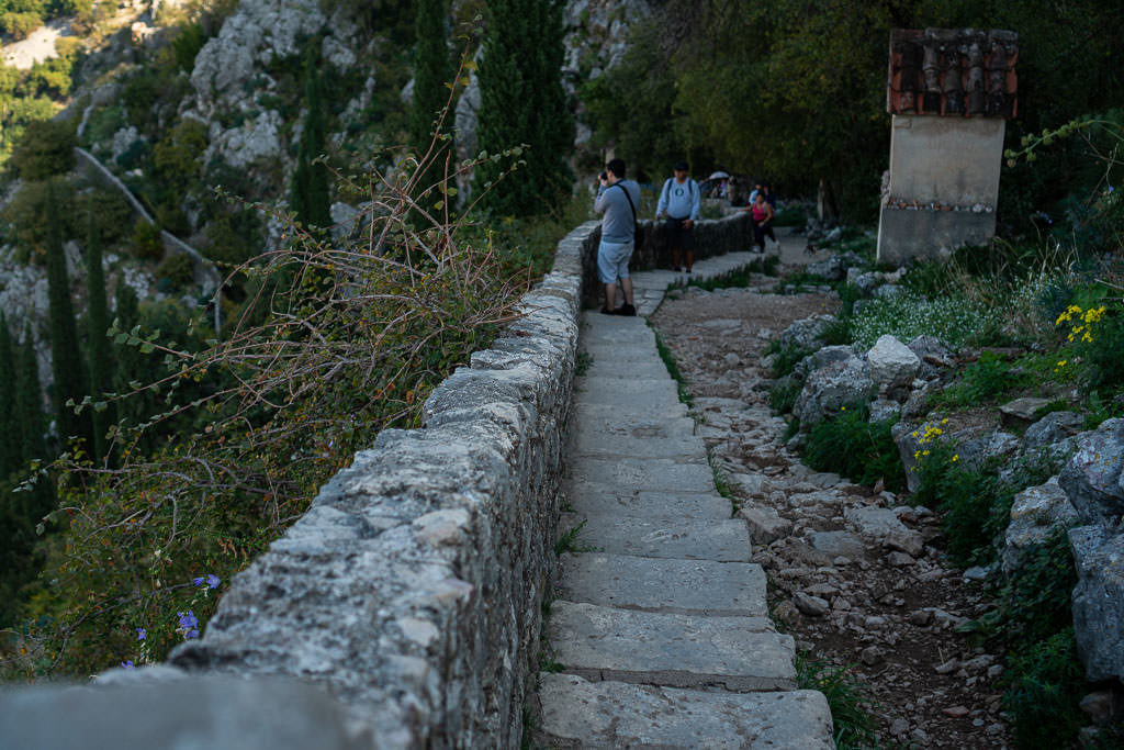 Some of the stairs leading to Kotor Fortress with a tourist taking photos