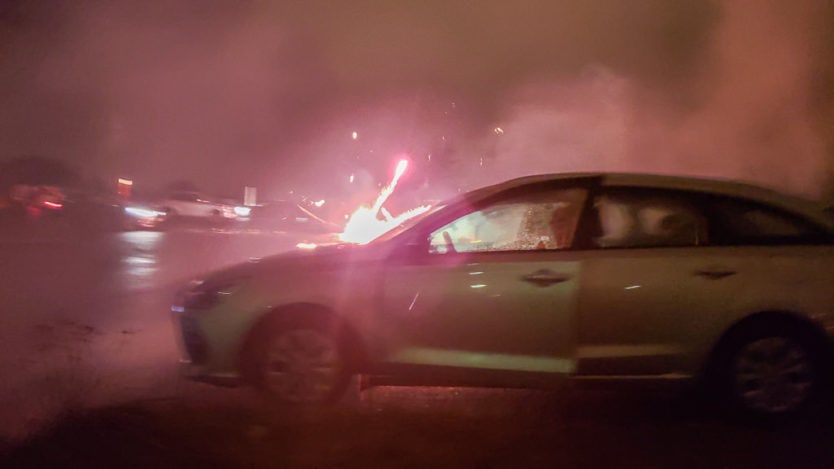 fireworks being shot off near car in parking lot at perlan on new year's eve