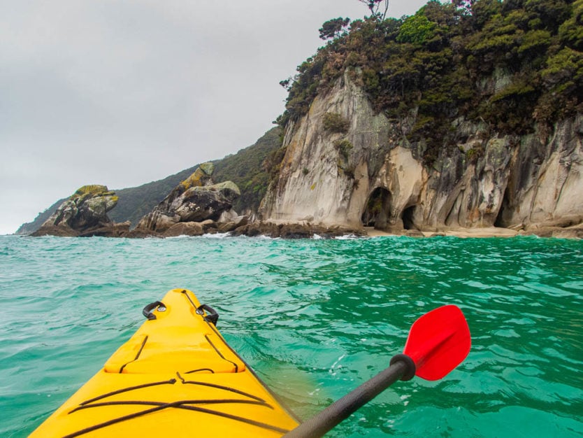 kayaking in abel tasman national park next to tonga arches in the tonga island marine reserve