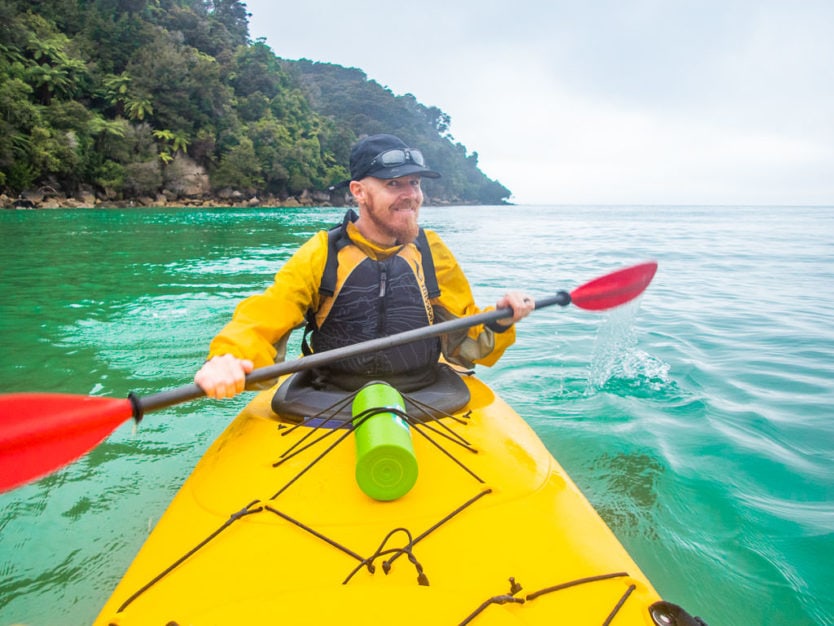 guy kayaking in abel tasman national park