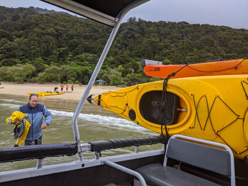 unloading the sea kayaks from the water taxi in abel tasman national park