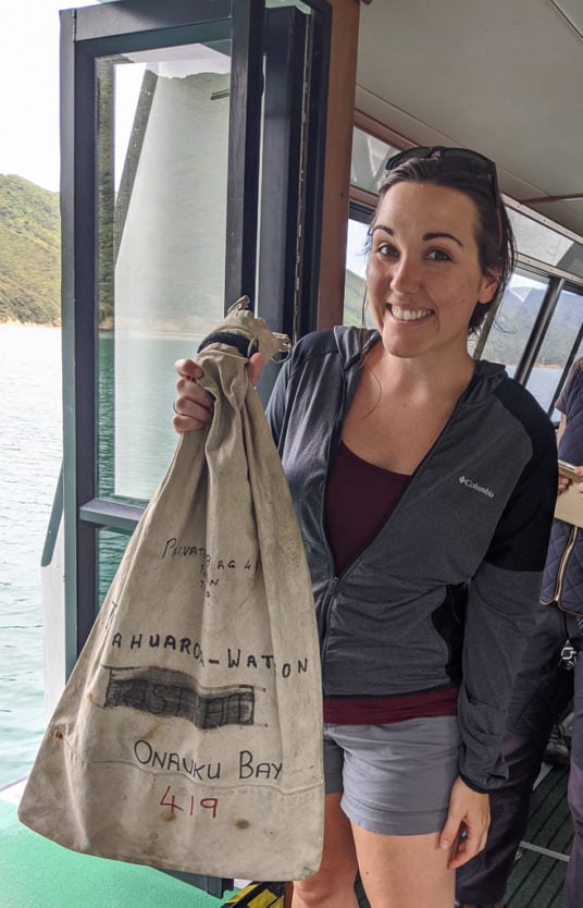 passenger on the mail picton boat cruise in queen charlotte sound preparing to deliver mail to local