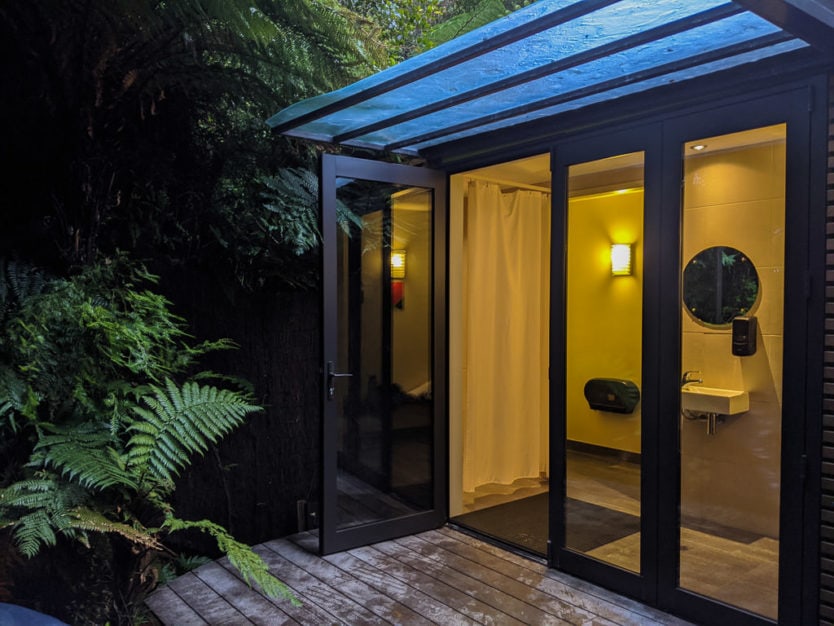 private shower, toilet and changing area in a private pool at the franz josef glacier hot pools a peaceful new zealand hot spring
