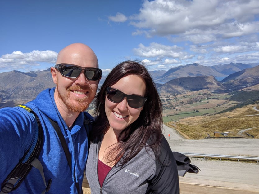 couple with mountain views from atop coronet peak