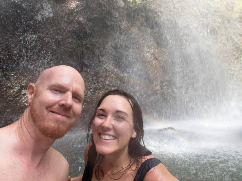 couple under secret falls in kauai hawaii