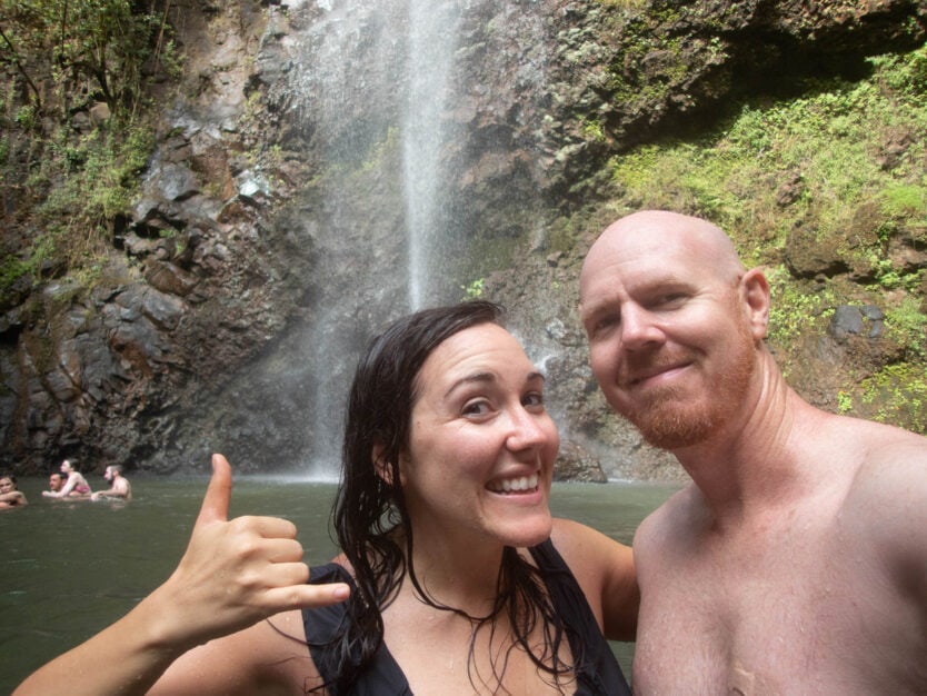 couple under secret falls in kauai hawaii