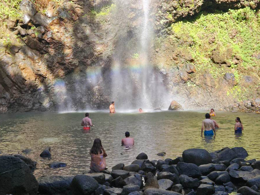 rainbow in pool of secret falls on kauai